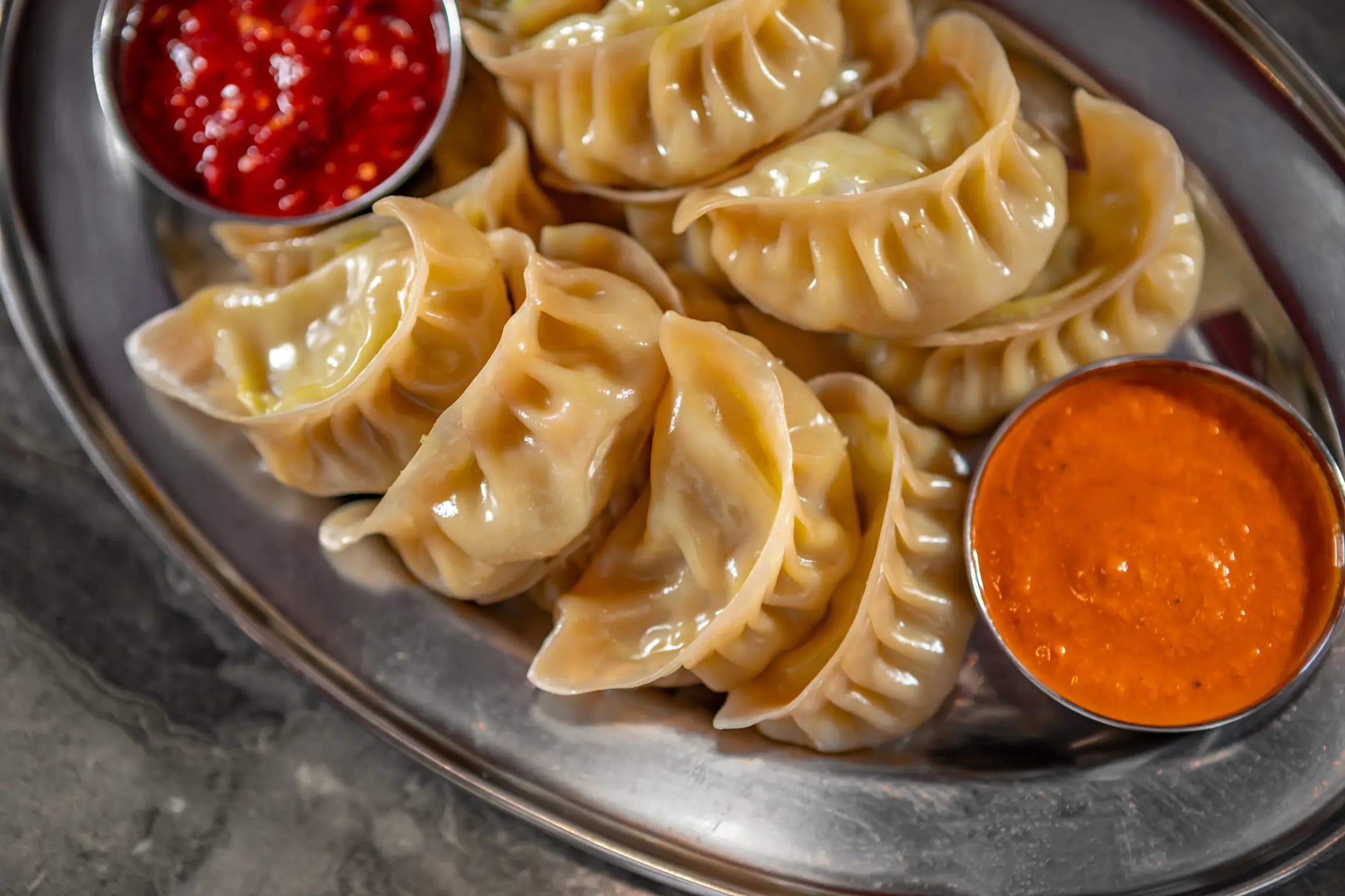 Plate of fresh steamed chicken momo dumplings